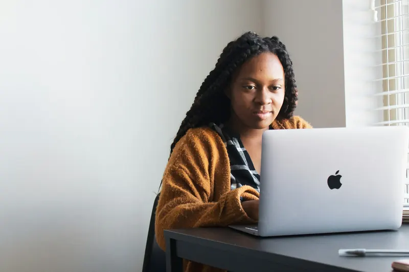 Woman writing SEO blog content on a laptop